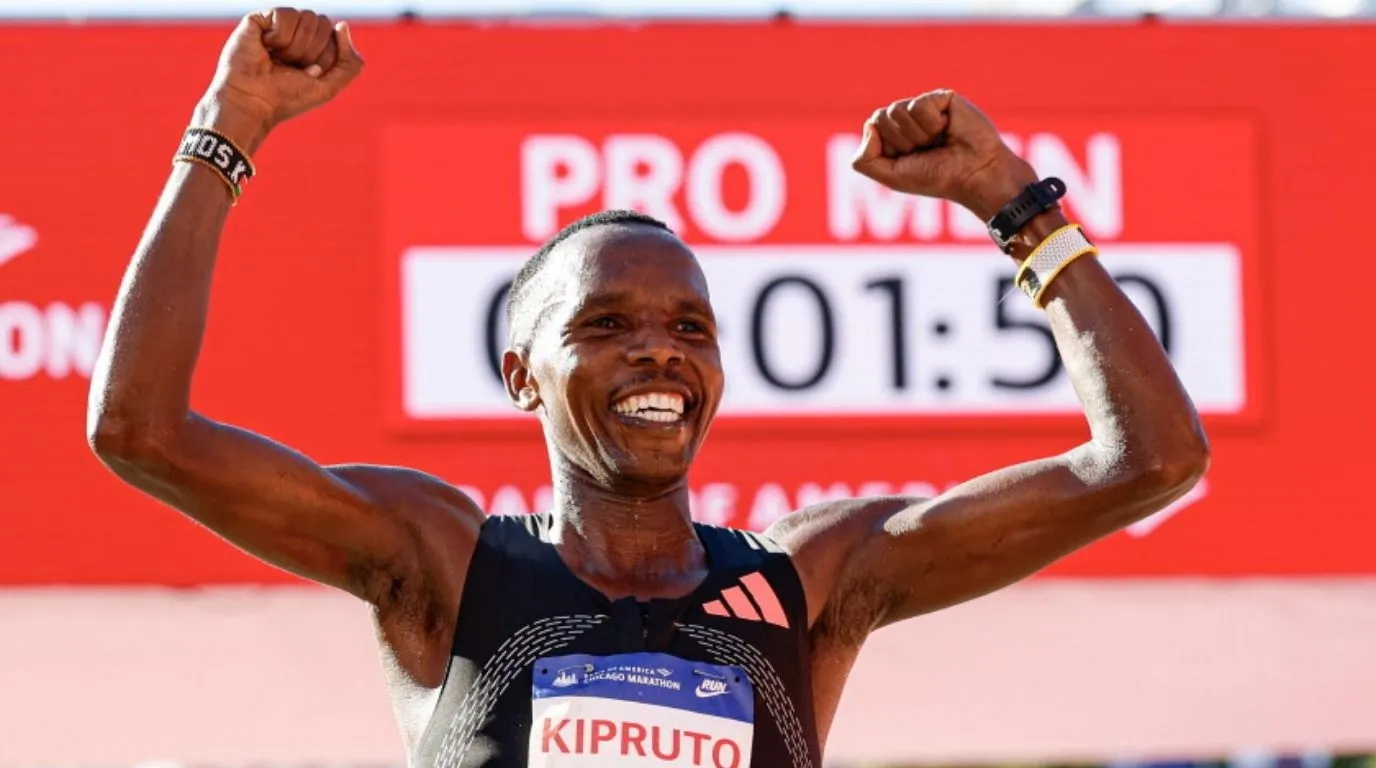 Amos Kipruto celebrates with his arms raised after winning the 2026 Bank of America Chicago Marathon.